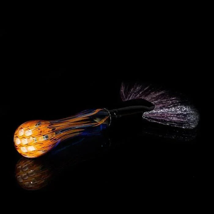 Handblown glass pipe with orange honeycomb bowl and purple fumed stem, studio shot on black