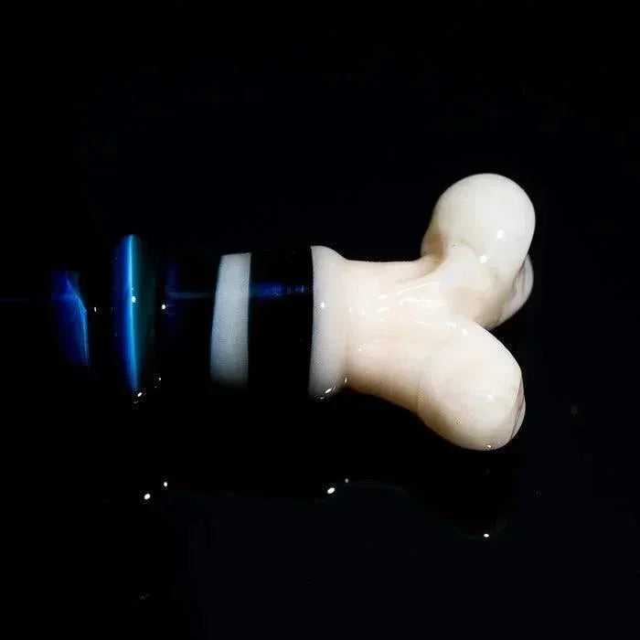 Hand-blown glass pipe with bone-shaped mouthpiece and blue accents, studio-lit against black background