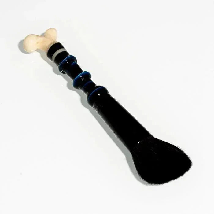 Black glass pipe with bone handle and blue accents, ideal for heady glass collectors