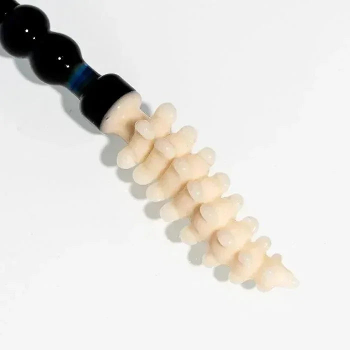 Handcrafted glass pipe with black and blue accents and textured spine design