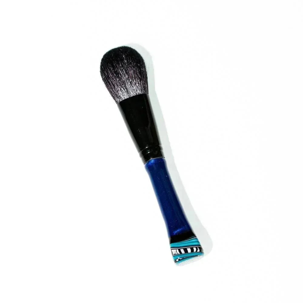 Blush makeup brush with black bristles and a blue handle on a white background.