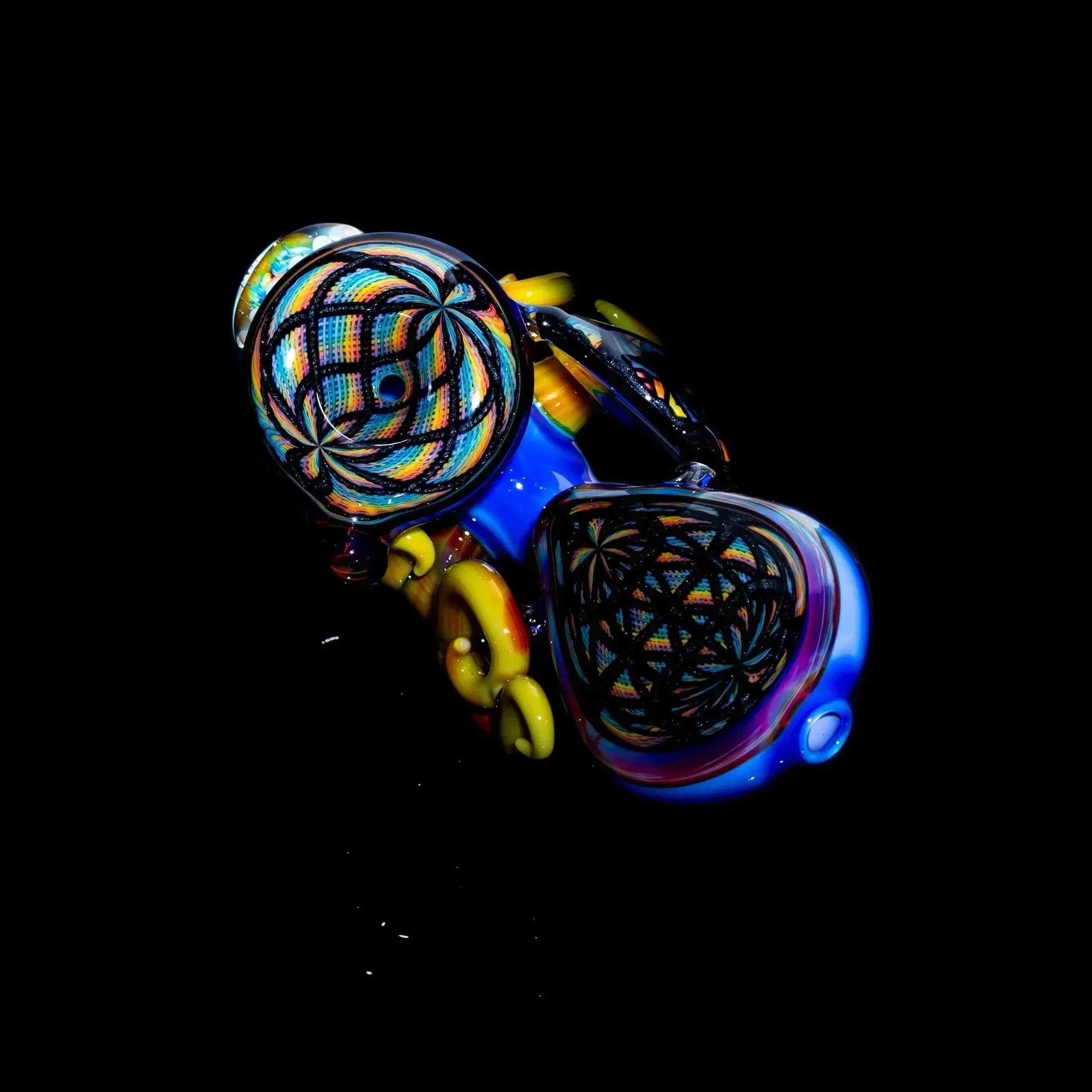 Colorful lattice retticello glass sherlock pipe with intricate patterns on black background