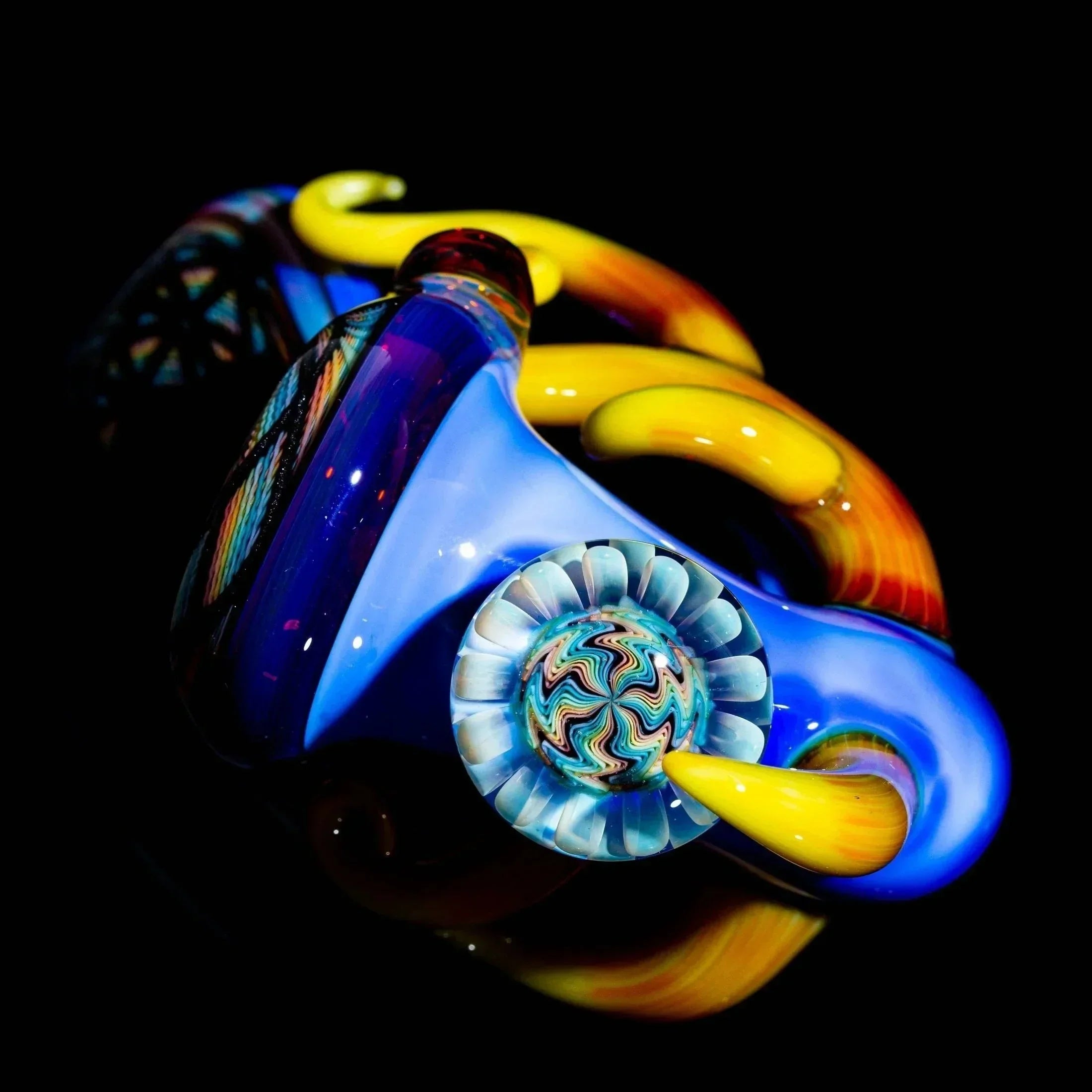 Colorful glass sherlock pipe with lattice design, blue and yellow swirls on black background