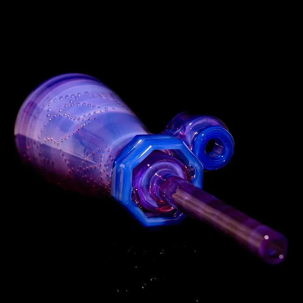 Purple glass hand pipe with detailed patterns and octagonal mouthpiece on black background