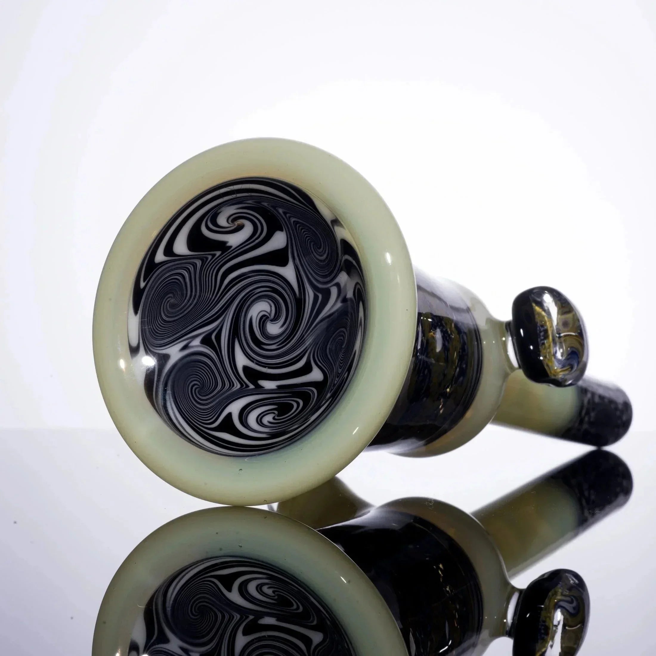 Handblown glass pipe with black and white swirl design, glossy finish, reflective surface