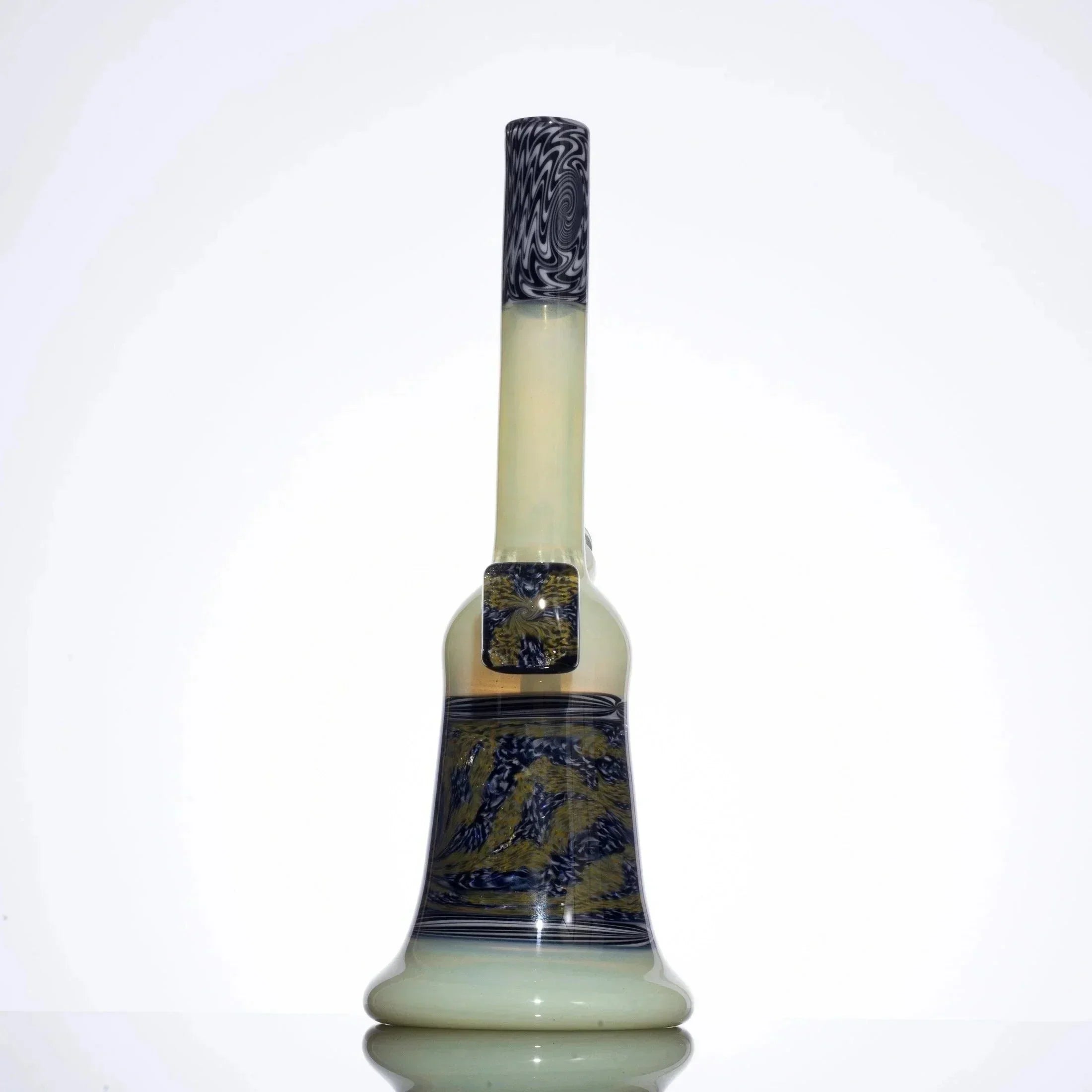 Hand-blown glass bong with black and gold swirls, opaque white base, and intricate artwork