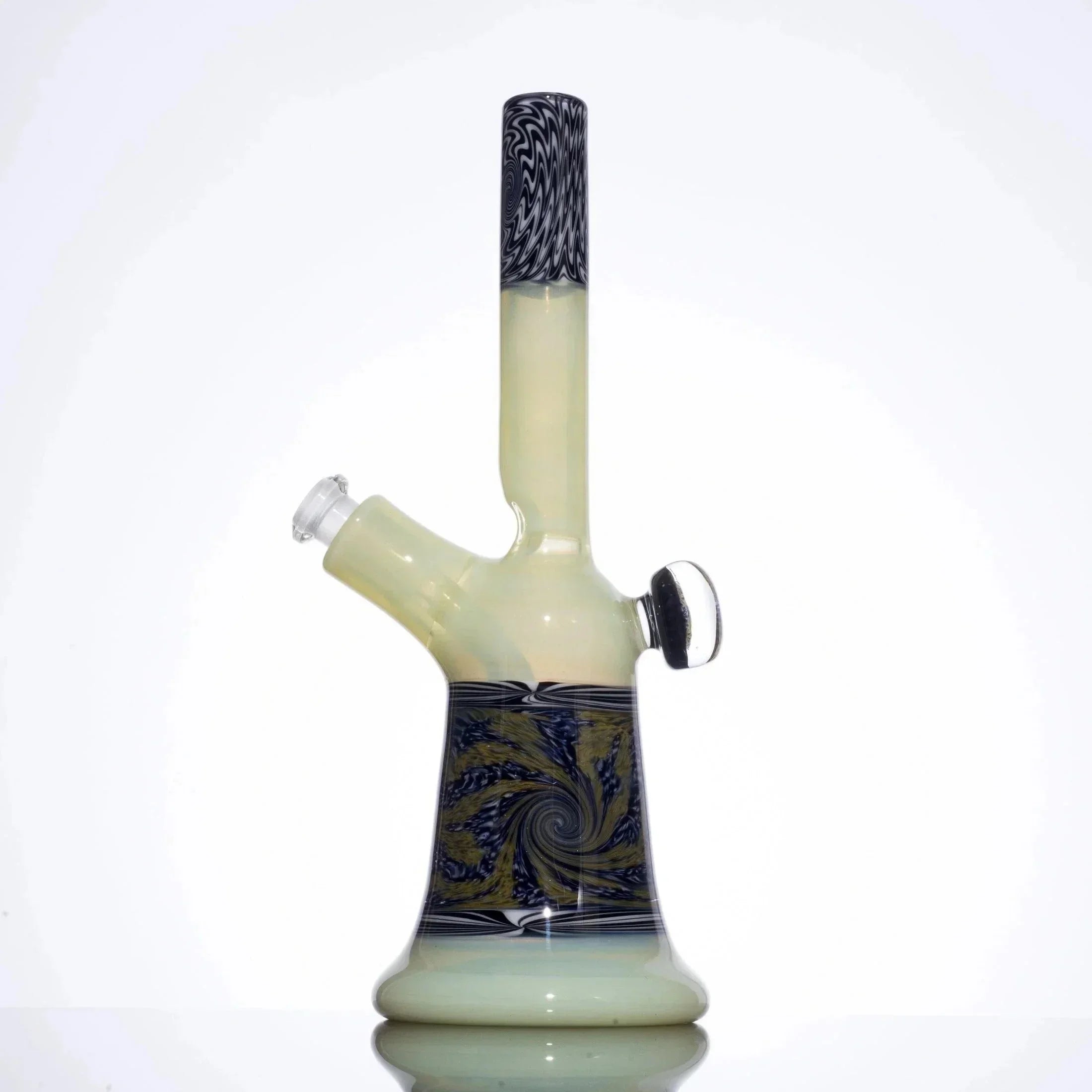 Hand-blown glass bong with swirling black, white, and gold patterns, featuring a tall neck and angled mouthpiece.