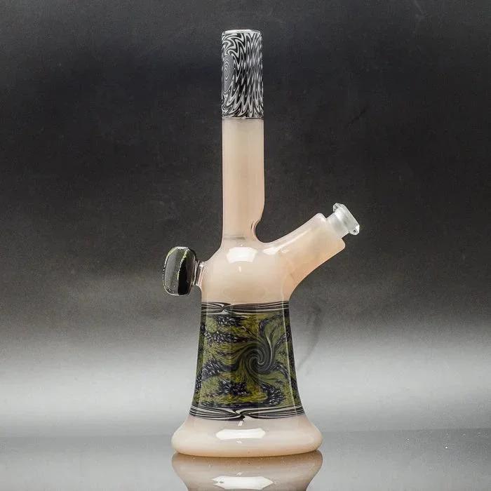 Handblown glass bong with swirl art, black and green accents, and a clear mouthpiece on reflective surface.