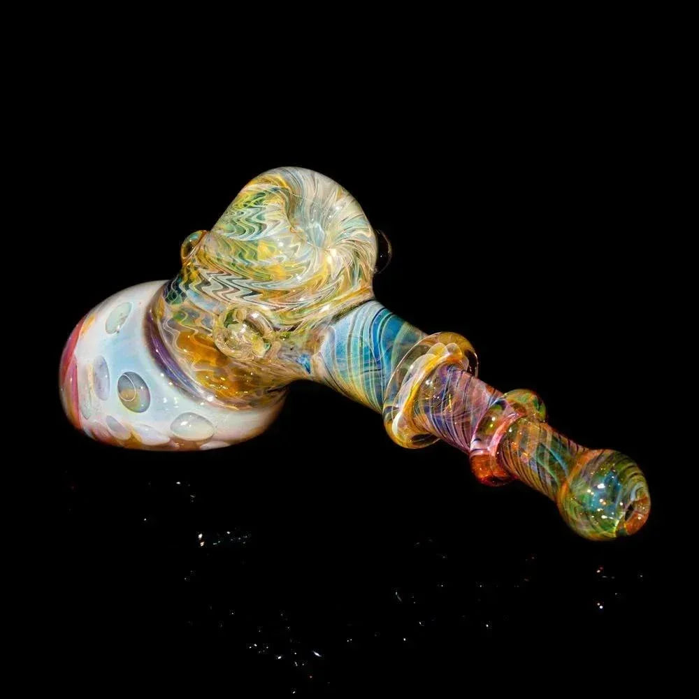 Colorful hand-blown glass hammer pipe with intricate swirling patterns on black background