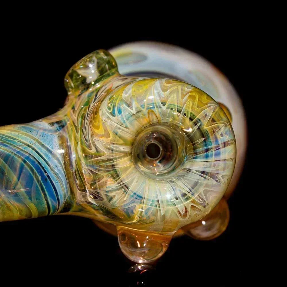 Close-up of a colorful glass hand pipe with intricate swirls and detailed fume work
