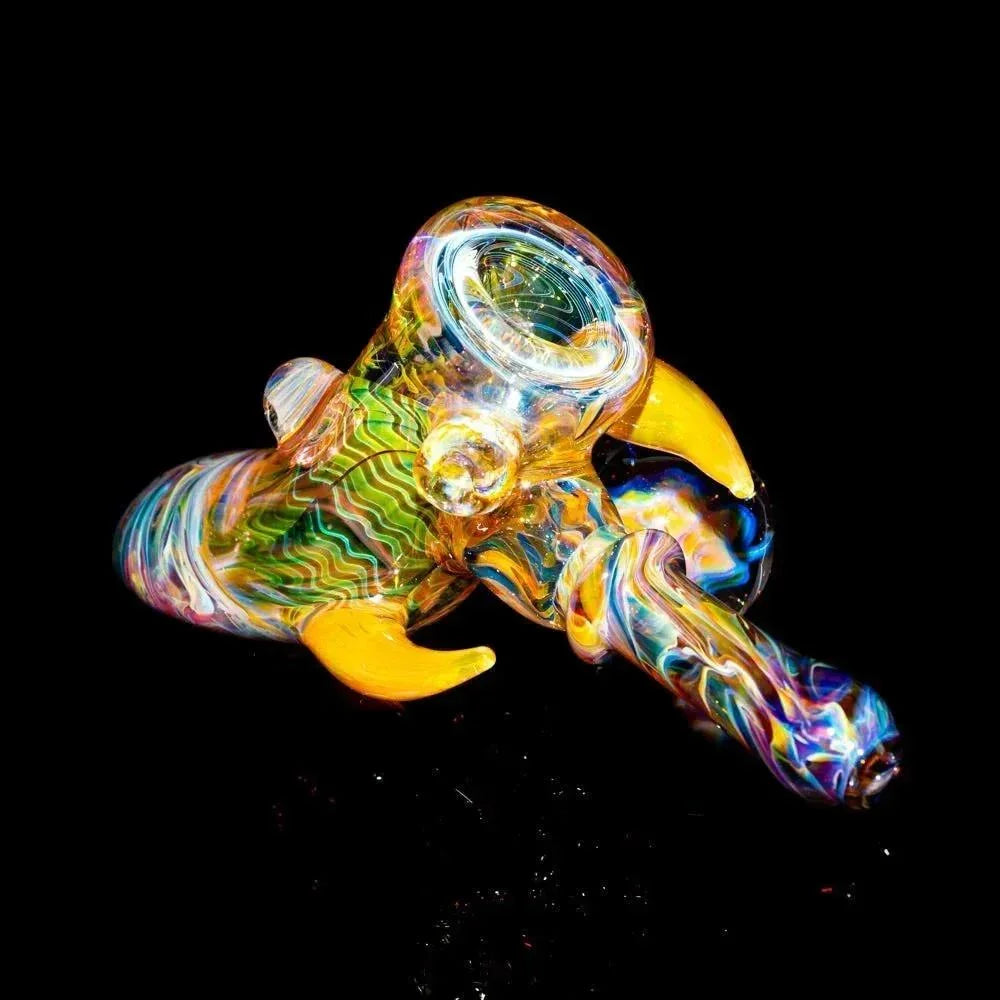 Colorful hand-blown glass pipe with swirling patterns and yellow accents on black background