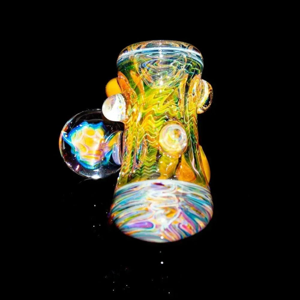 Colorful heady glass pipe with swirling patterns and marble accents on black background