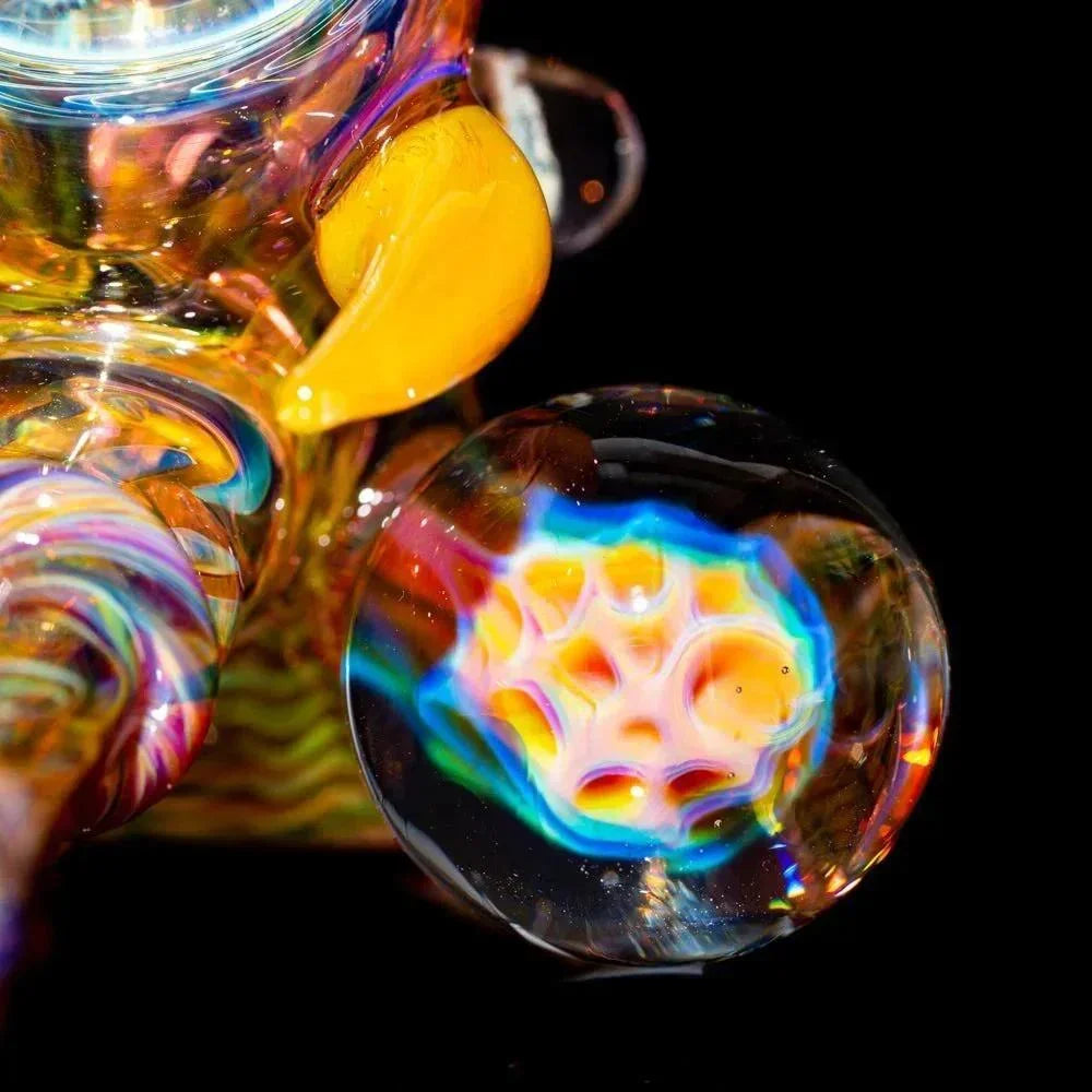 Close-up of colorful heady glass pipe with intricate patterns and vibrant marble accent