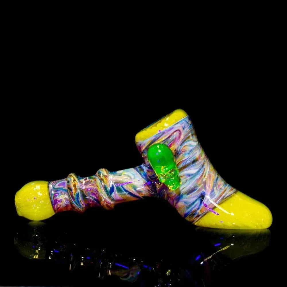 Colorful glass hammer pipe with yellow accents and green marble detail on a black background