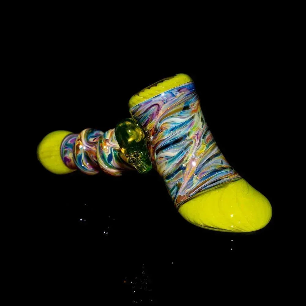 Colorful glass hammer pipe with yellow ends and vibrant swirled patterns on black background