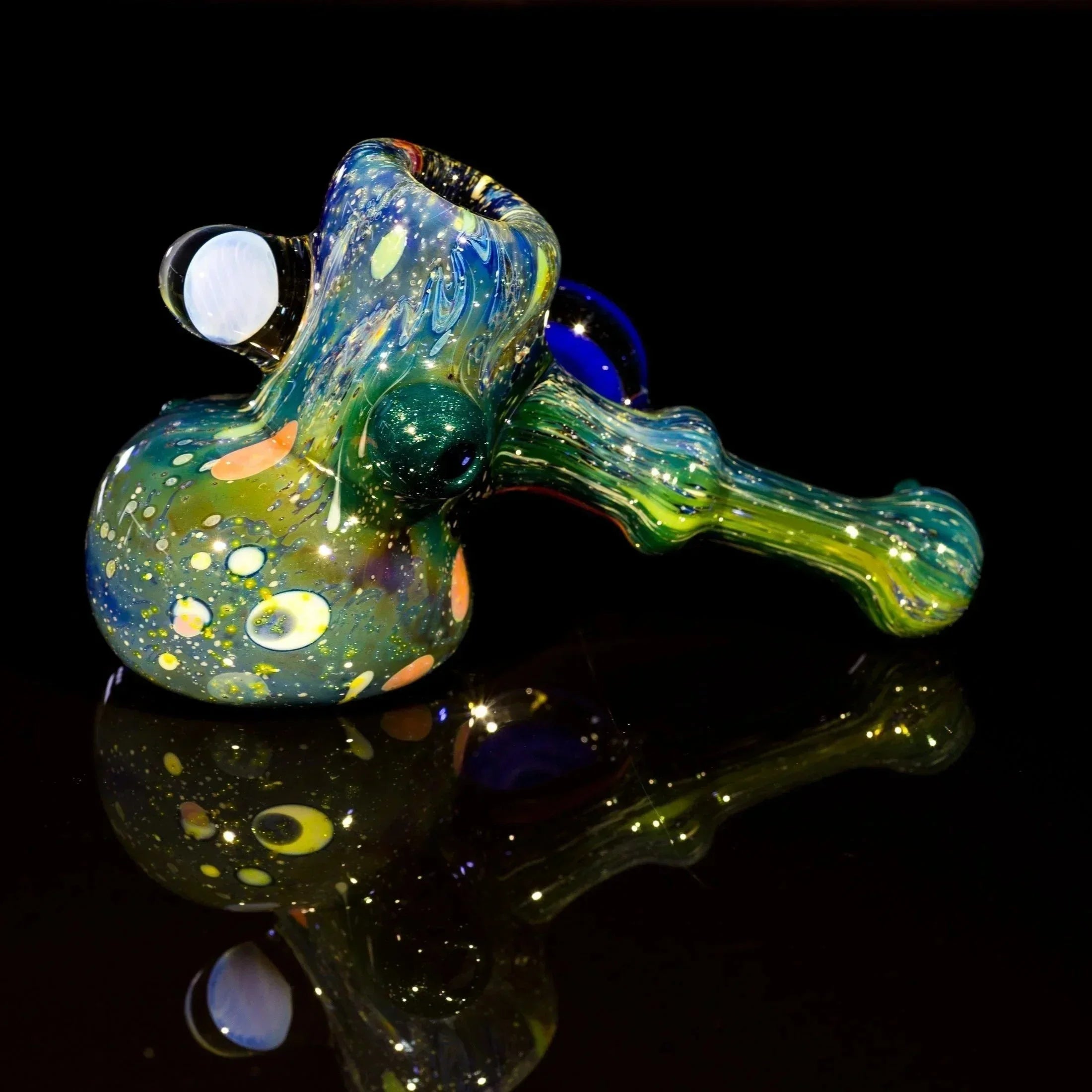 Colorful heady glass pipe with swirls and bubbles, reflective surface, black background