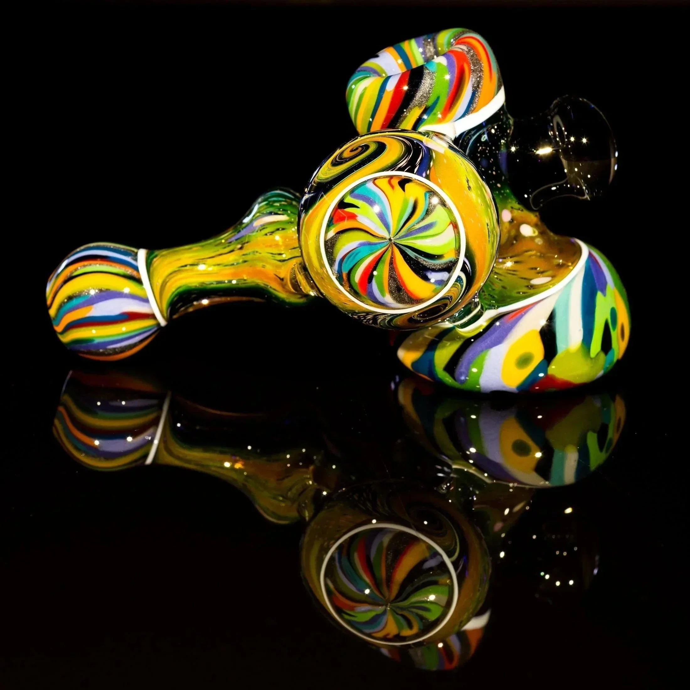 Vibrant rainbow swirl glass pipe with intricate patterns, displayed on reflective black surface.