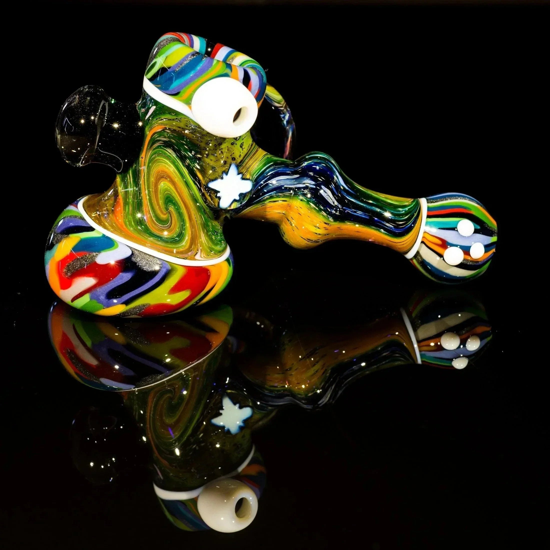 Colorful swirled glass pipe with star accents, reflective surface, heady glass art piece