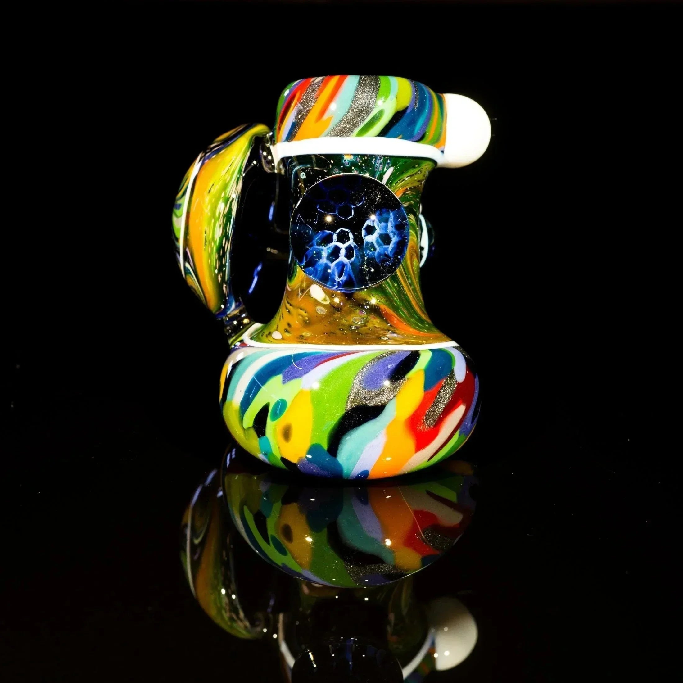 Colorful heady glass pipe with swirls and blue honeycomb design, reflective surface