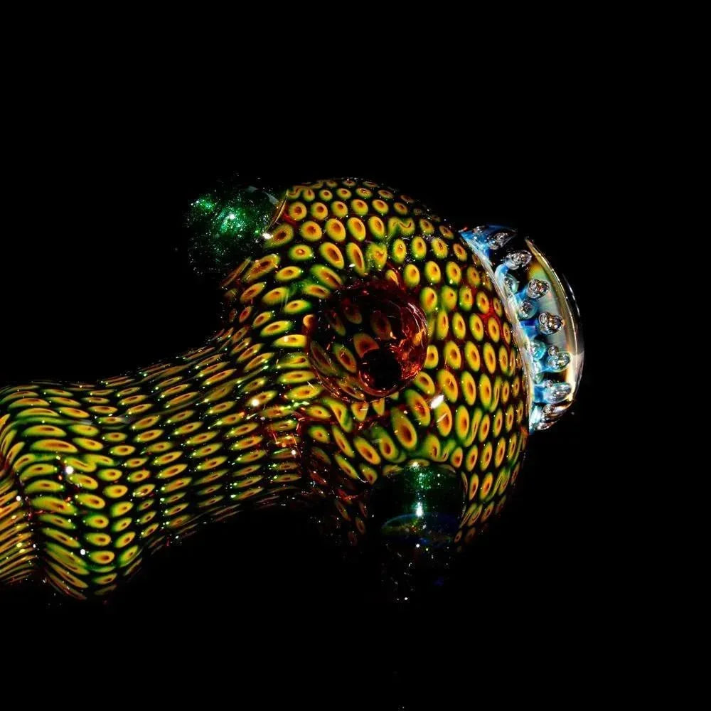 Colorful hand-blown glass spoon pipe with intricate anemone pattern on black background