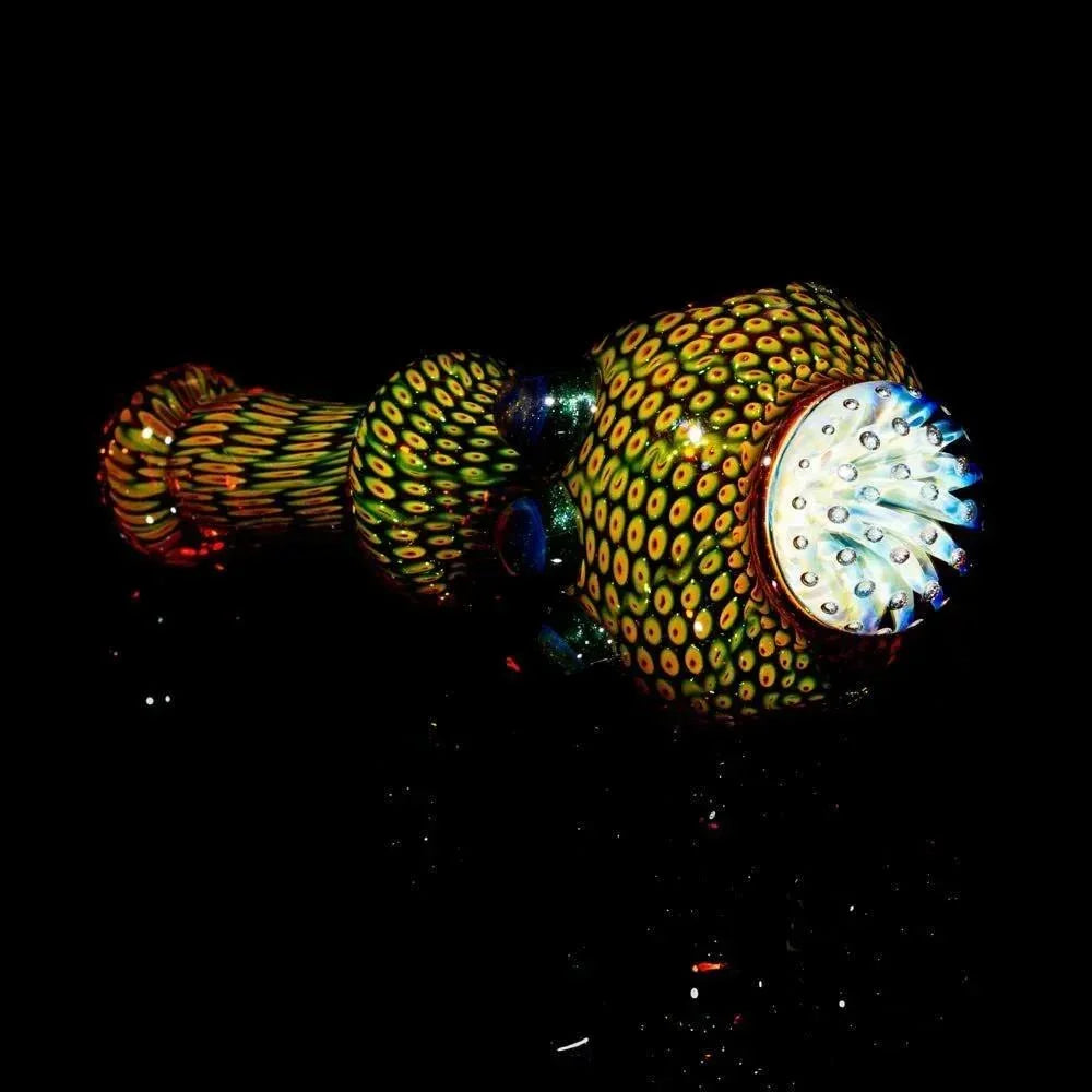 Handblown glass spoon pipe with colorful anemone-inspired pattern on a black background