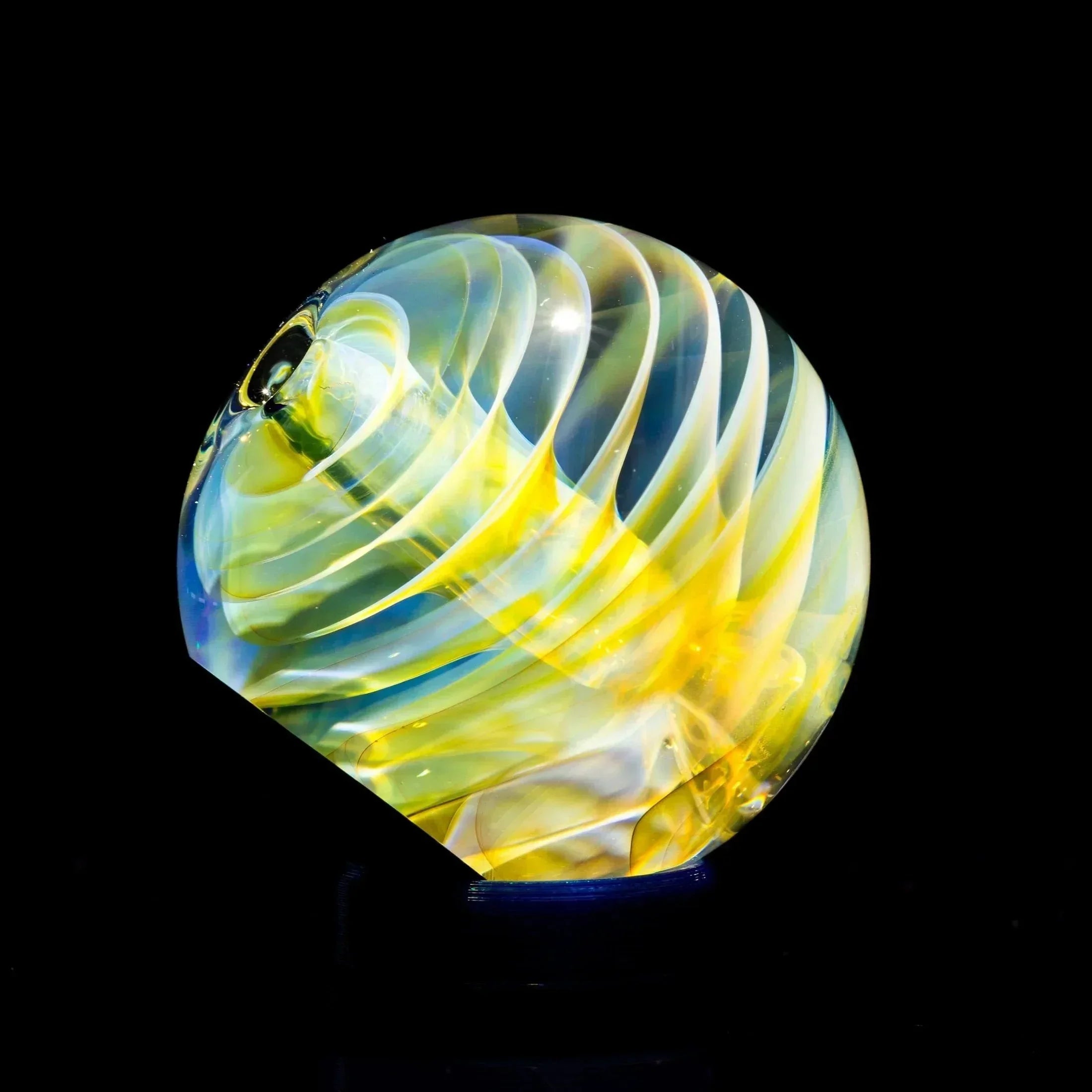 Hand-blown glass pipe with swirling yellow and blue patterns, showcasing heady glass artistry.