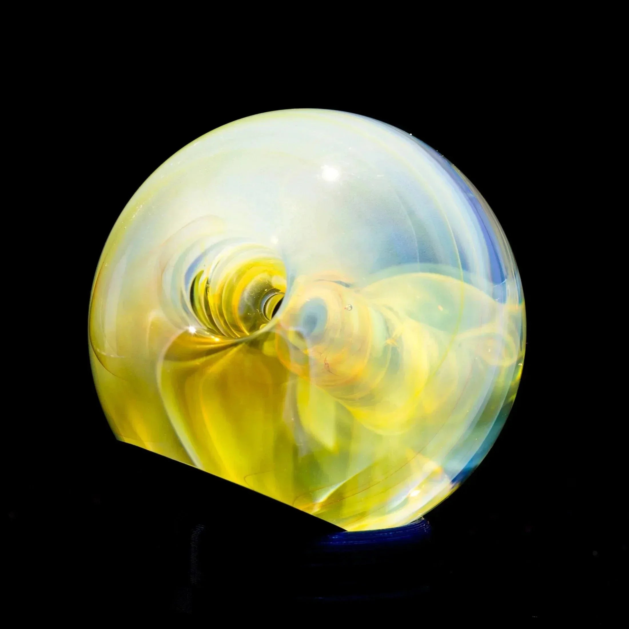 Heady glass pipe with swirling yellow and blue opalescent design, displayed on black background
