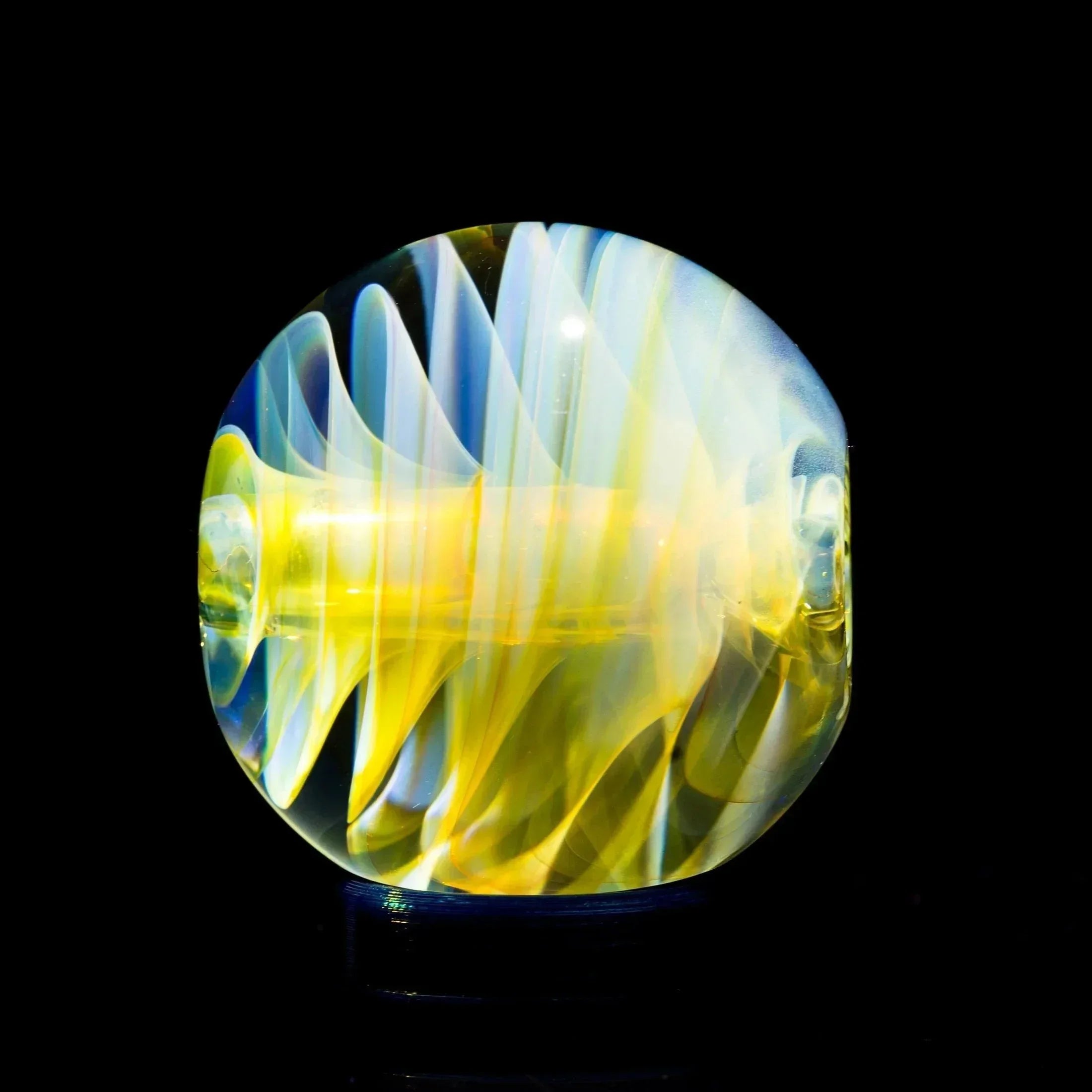 Vibrant yellow and blue swirled glass pipe bowl, showcasing heady glass artistry against black background