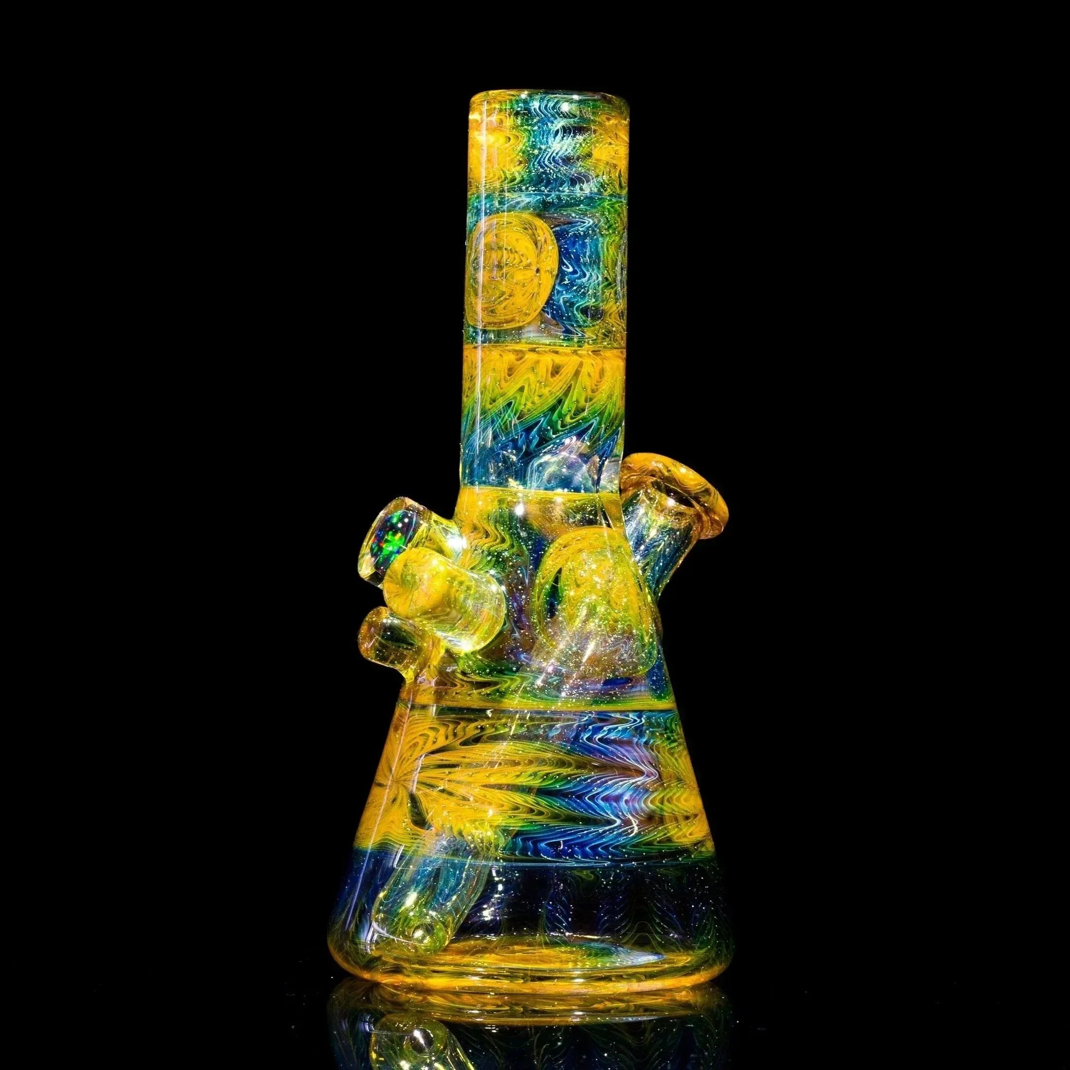 Vibrant yellow and blue swirled glass bong with intricate designs, showcasing heady glass artistry.