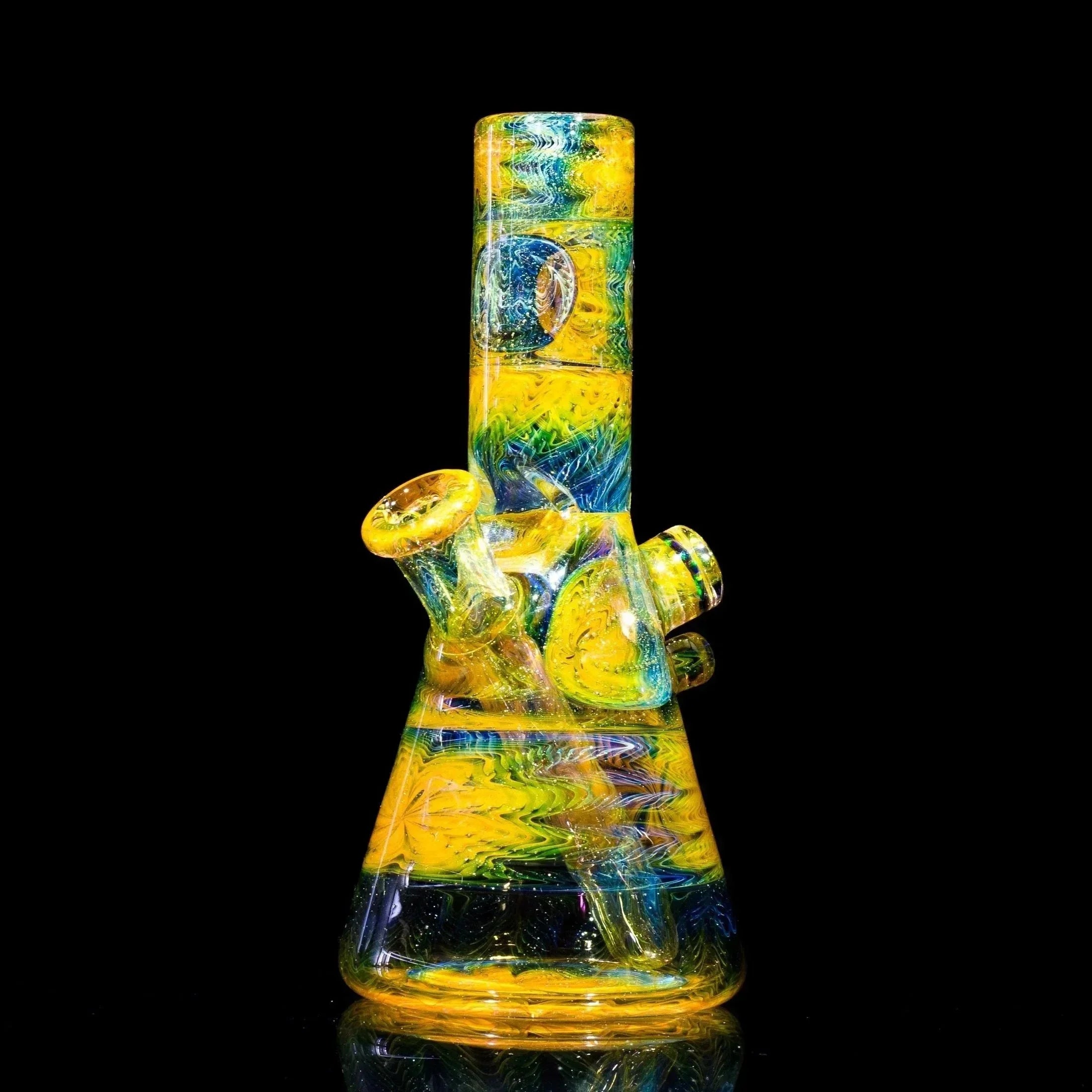 Vibrant yellow, blue, and green heady glass bong with swirling patterns and reflective surface