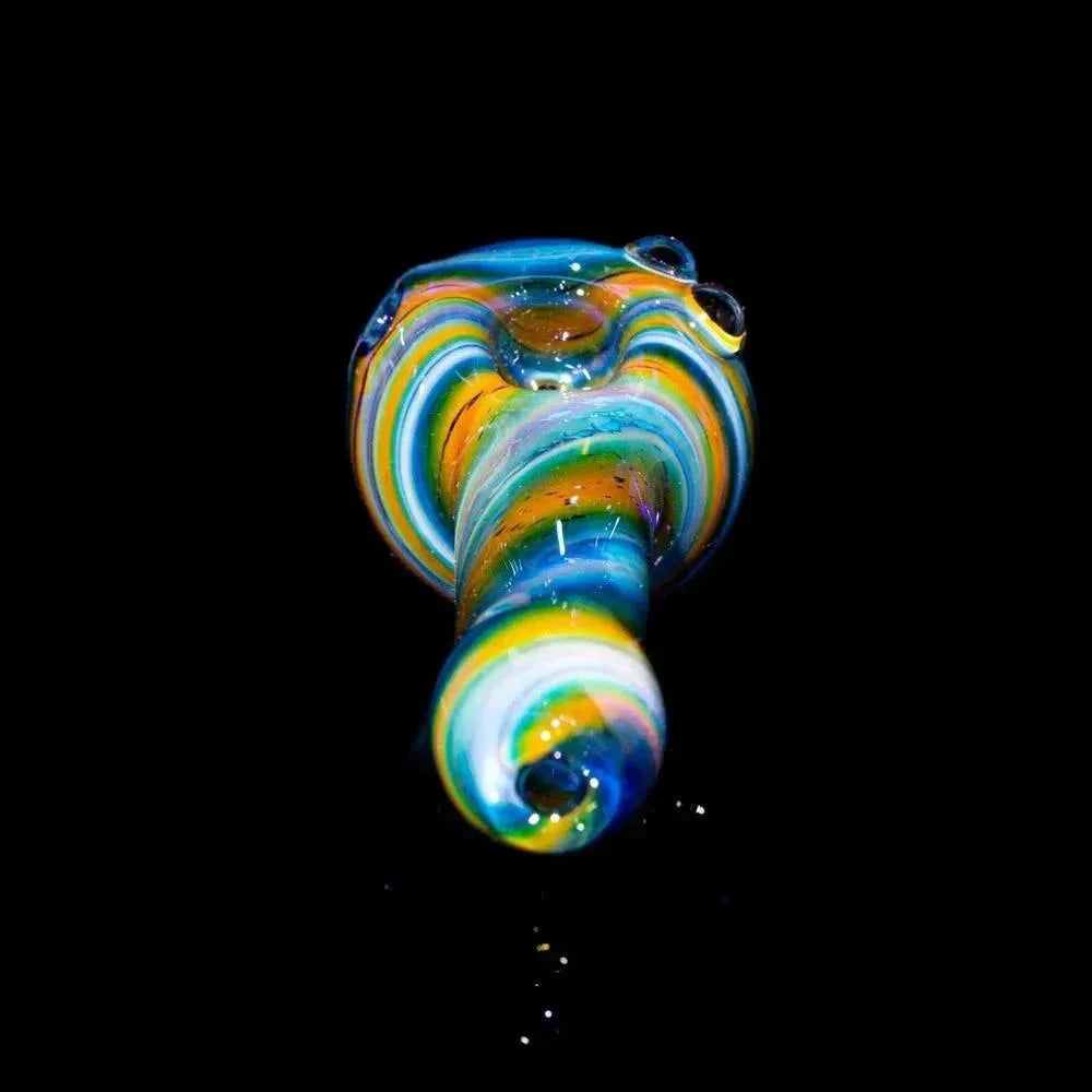 Colorful fumed glass spoon pipe with blue, yellow, and green swirls on black background