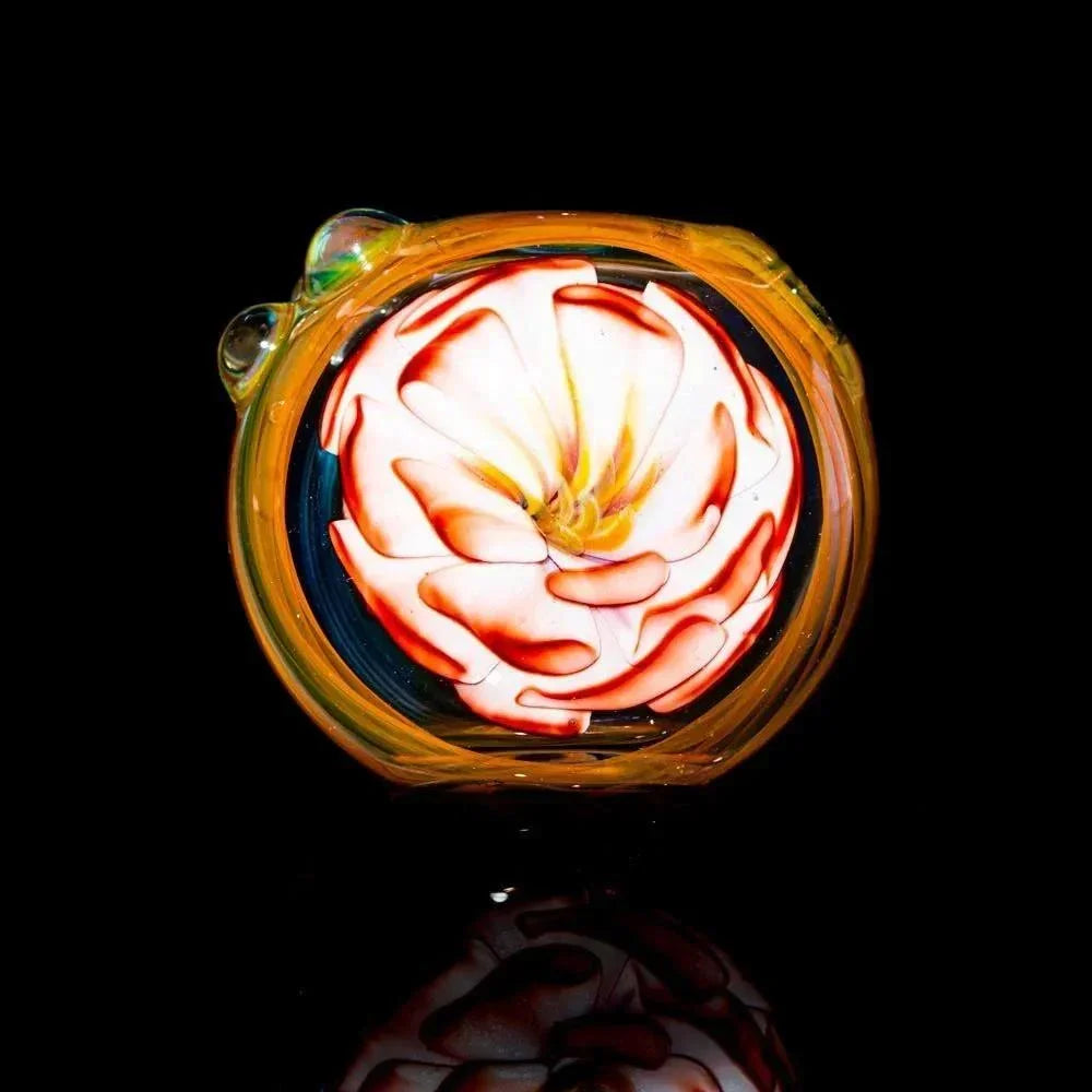 Handcrafted glass spoon pipe with rosy pink flower design and fumed details on black background