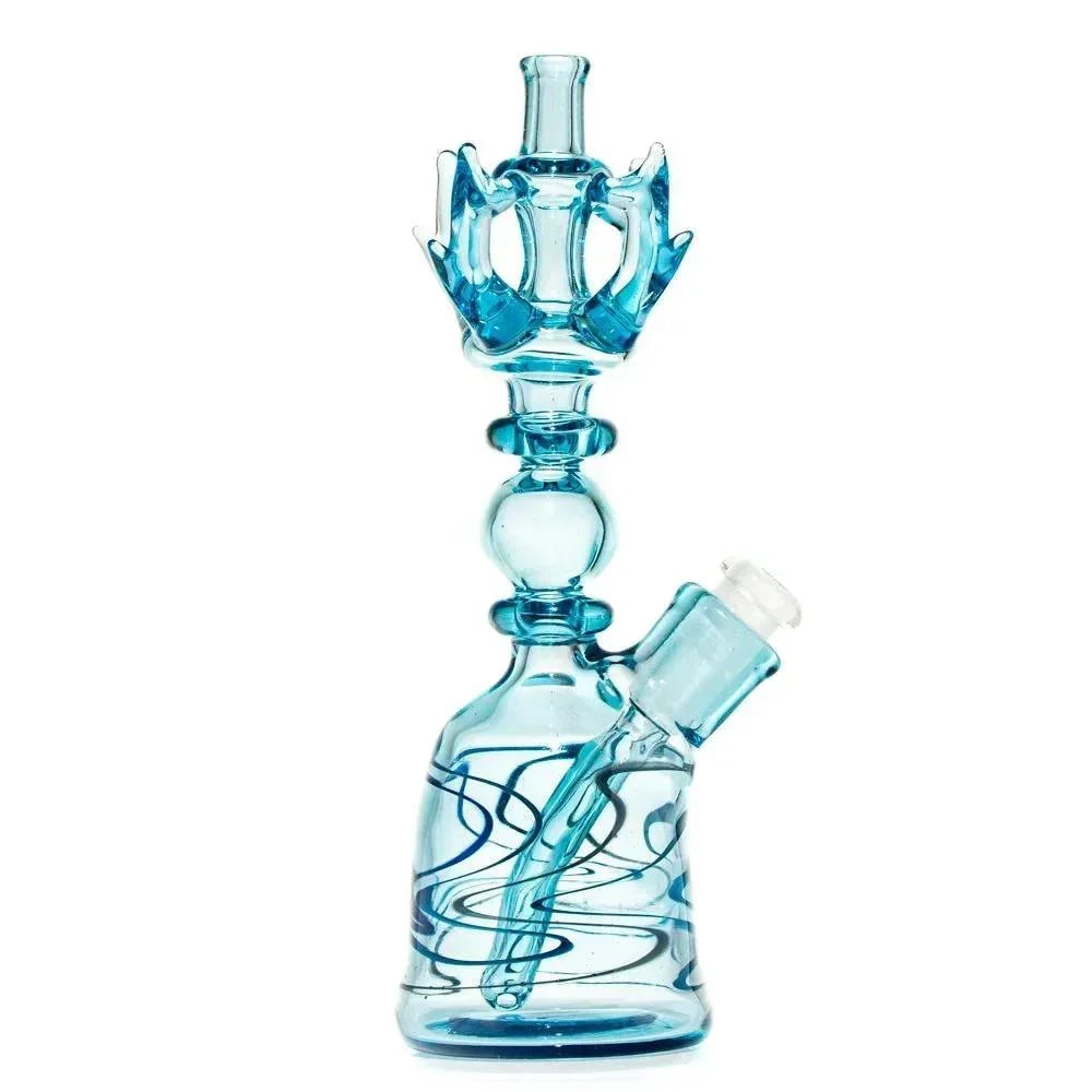 Blue glass water pipe with intricate swirls and crown-shaped accents, isolated on white