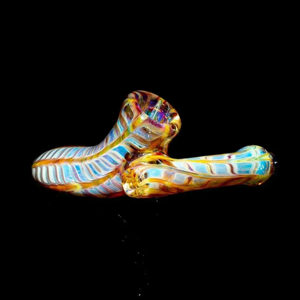Handblown amber and purple glass pipe with colorful accents on a black background