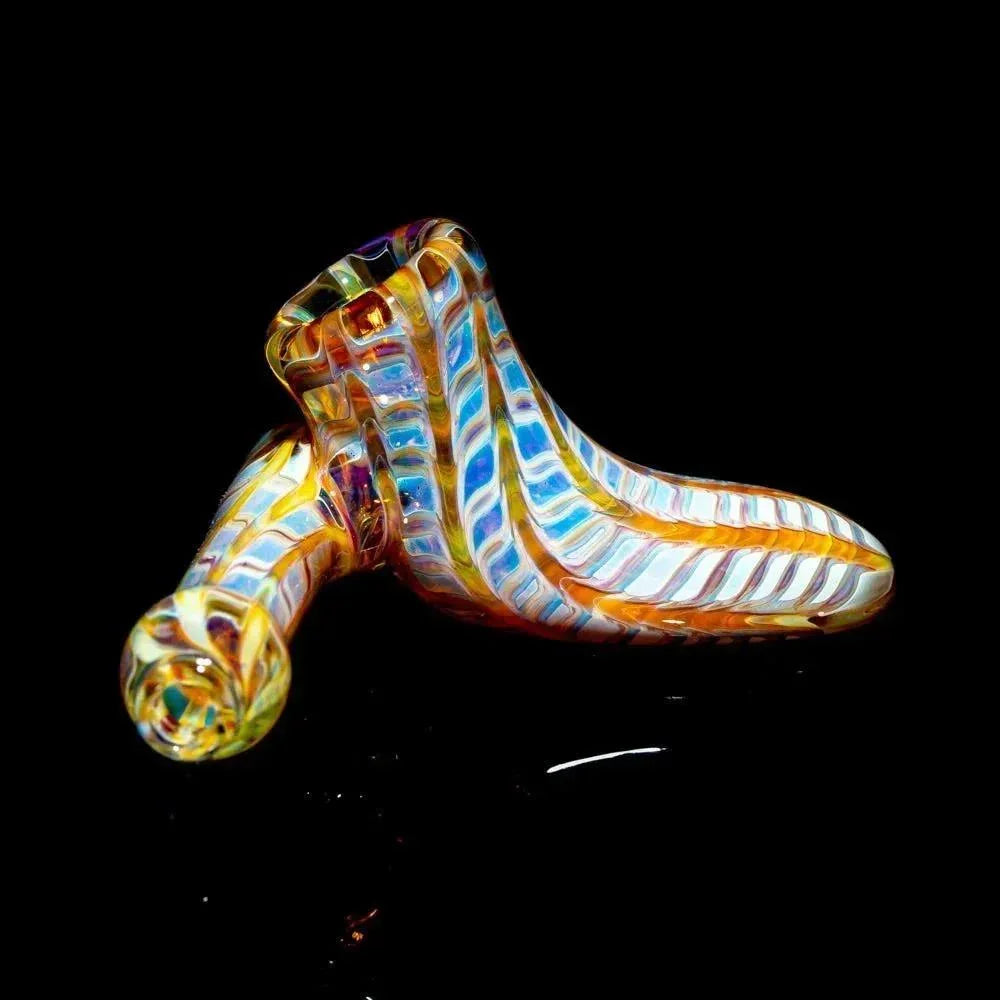 Amber and purple striped glass hand pipe with sidecar design on black background
