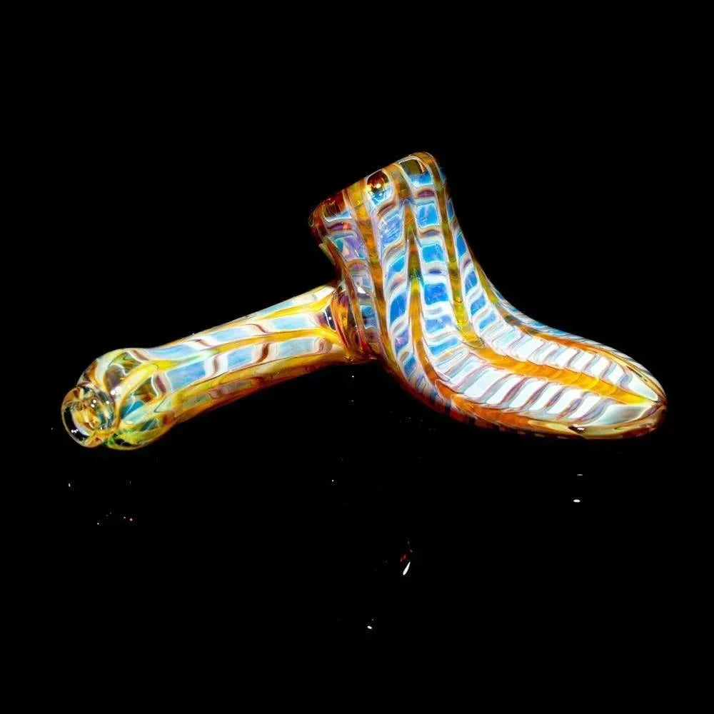 Amber and purple striped glass hand pipe with sidecar design on black background