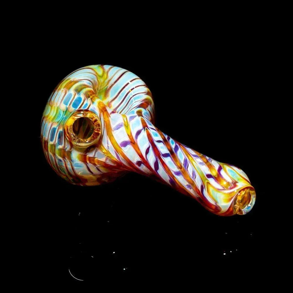 Colorful amber and purple glass spoon pipe with swirl design on black background