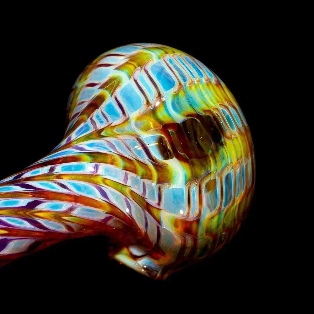 Colorful hand-blown glass pipe with amber, purple, and blue swirl design on black background