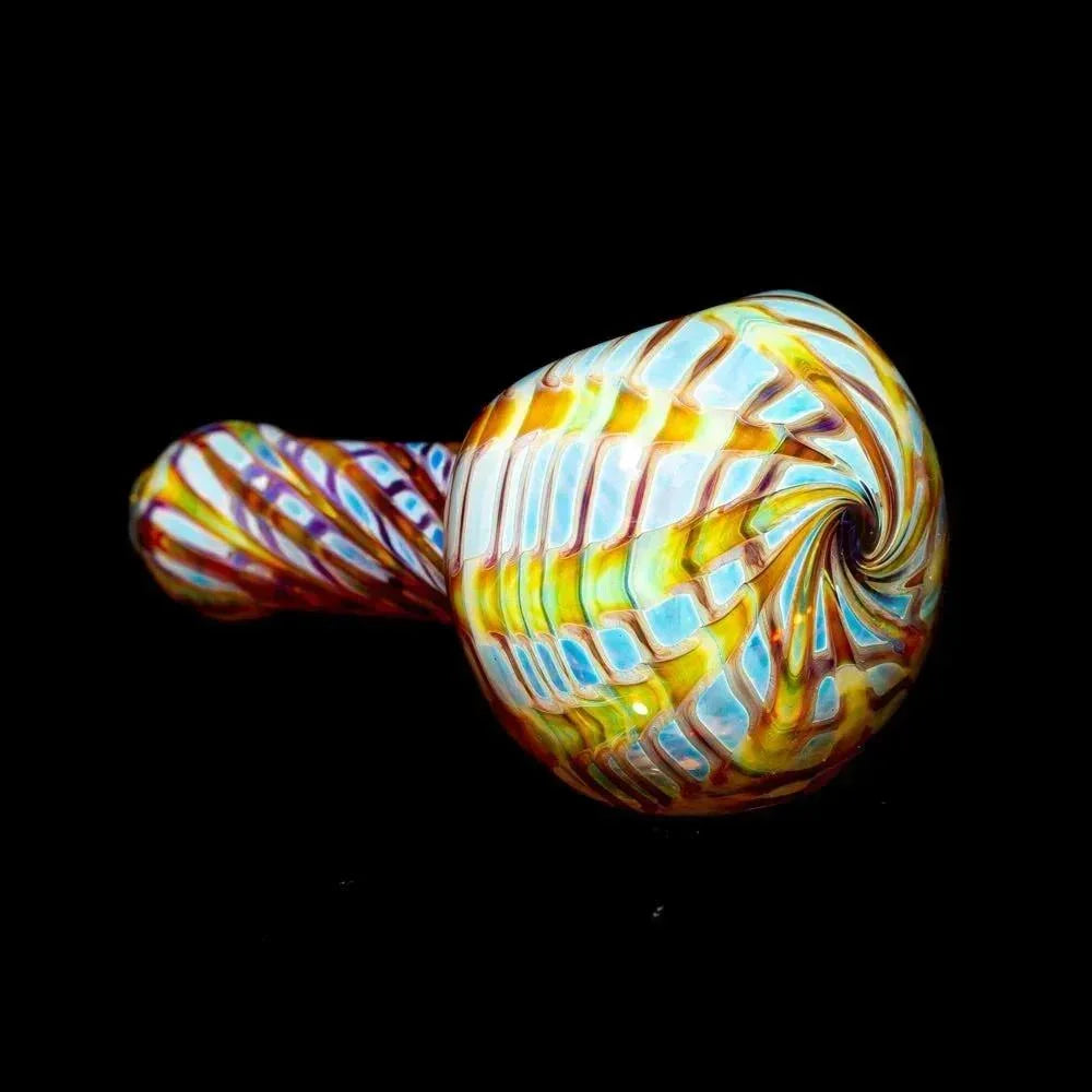 Amber and purple swirl glass hand pipe with intricate pattern on black background