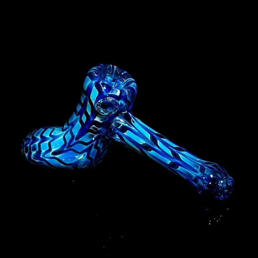 Blue patterned glass hand pipe with zigzag design on black background.