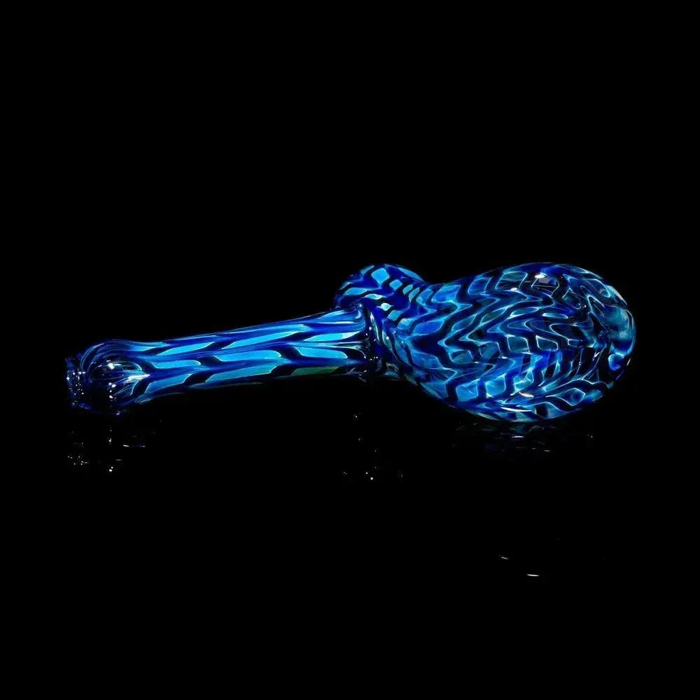 Blue patterned glass hand pipe with swirling designs on a black background