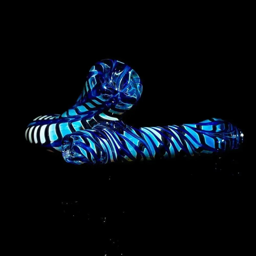 Blue and black striped glass hand pipe with intricate swirled design on black background