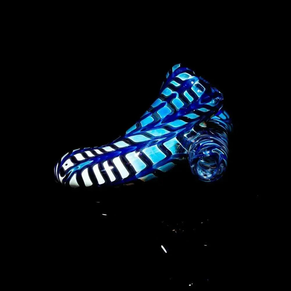 Handcrafted blue glass pipe with intricate white and blue patterns against a black background.