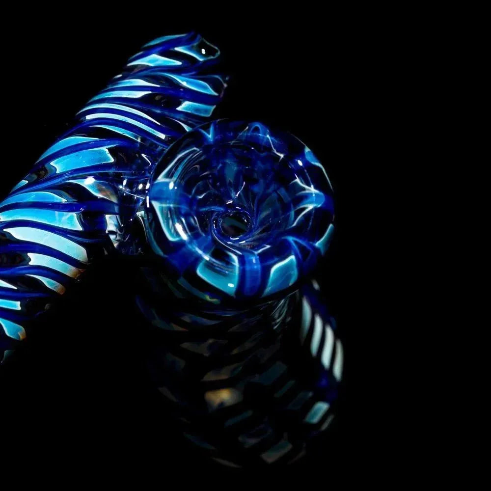 Blue glass hand pipe with spiral design for smoking, shown on black background.