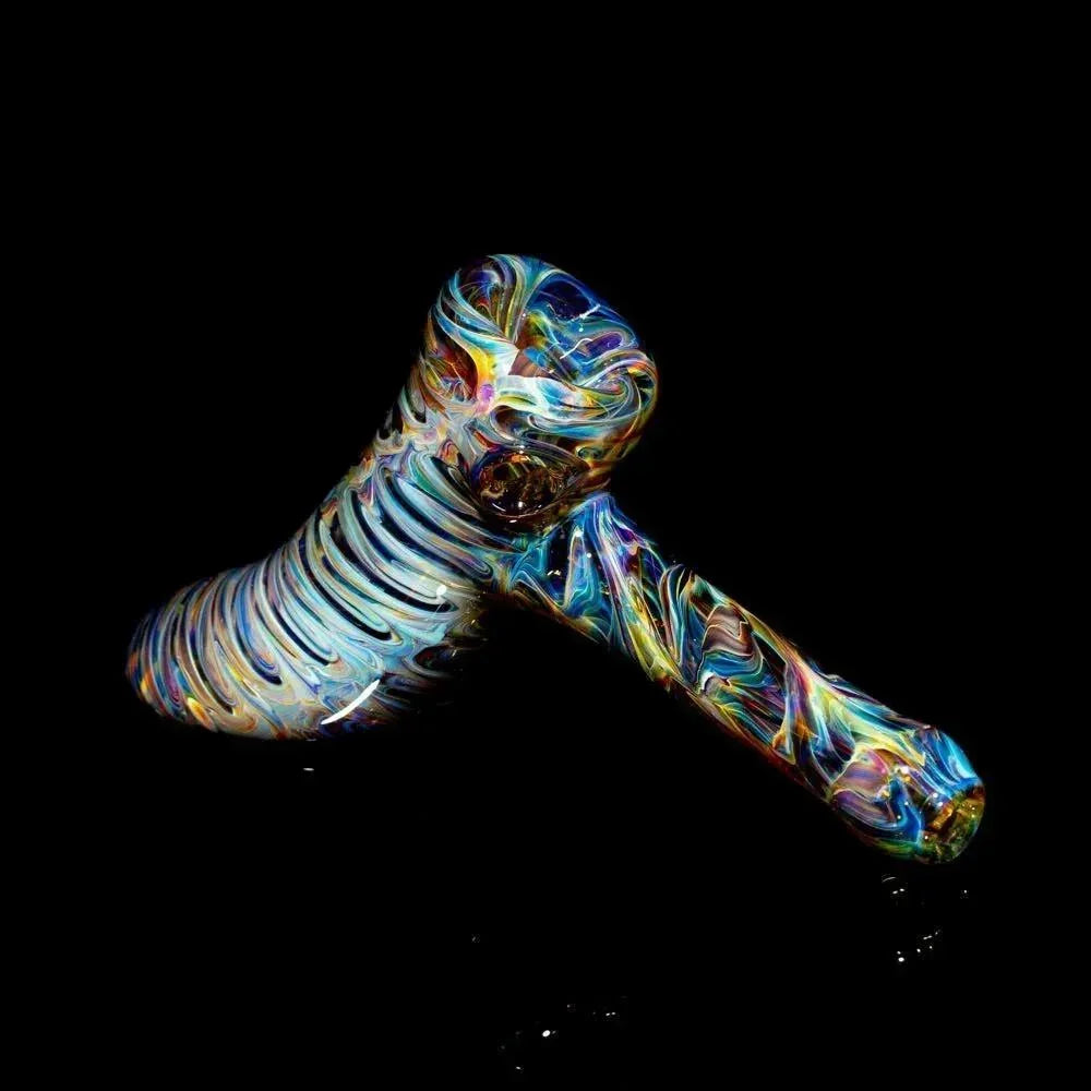 Tie-dye glass hammer pipe with colorful swirled patterns on a black background.