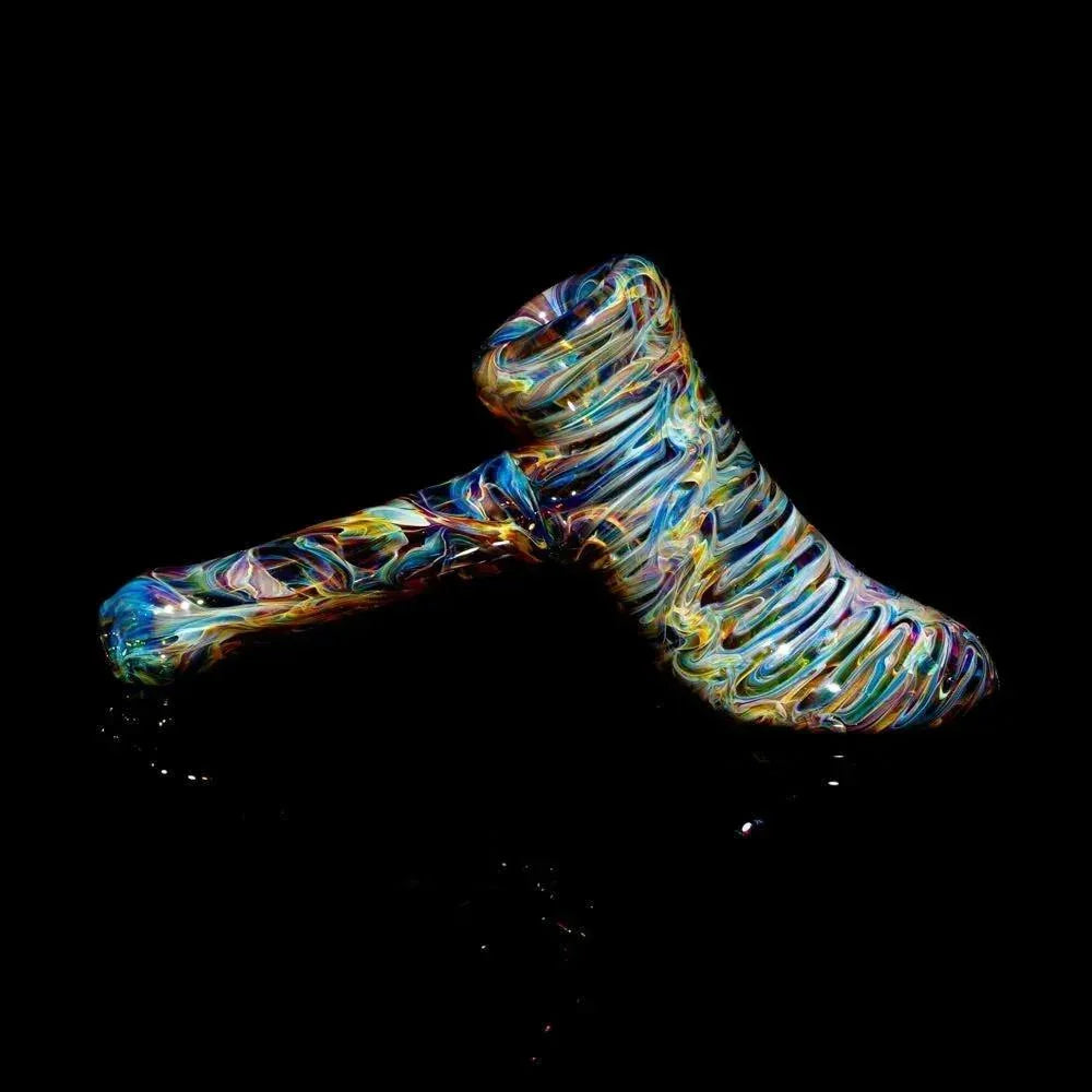 Colorful tie-dye glass hammer pipe with swirling patterns on a black background