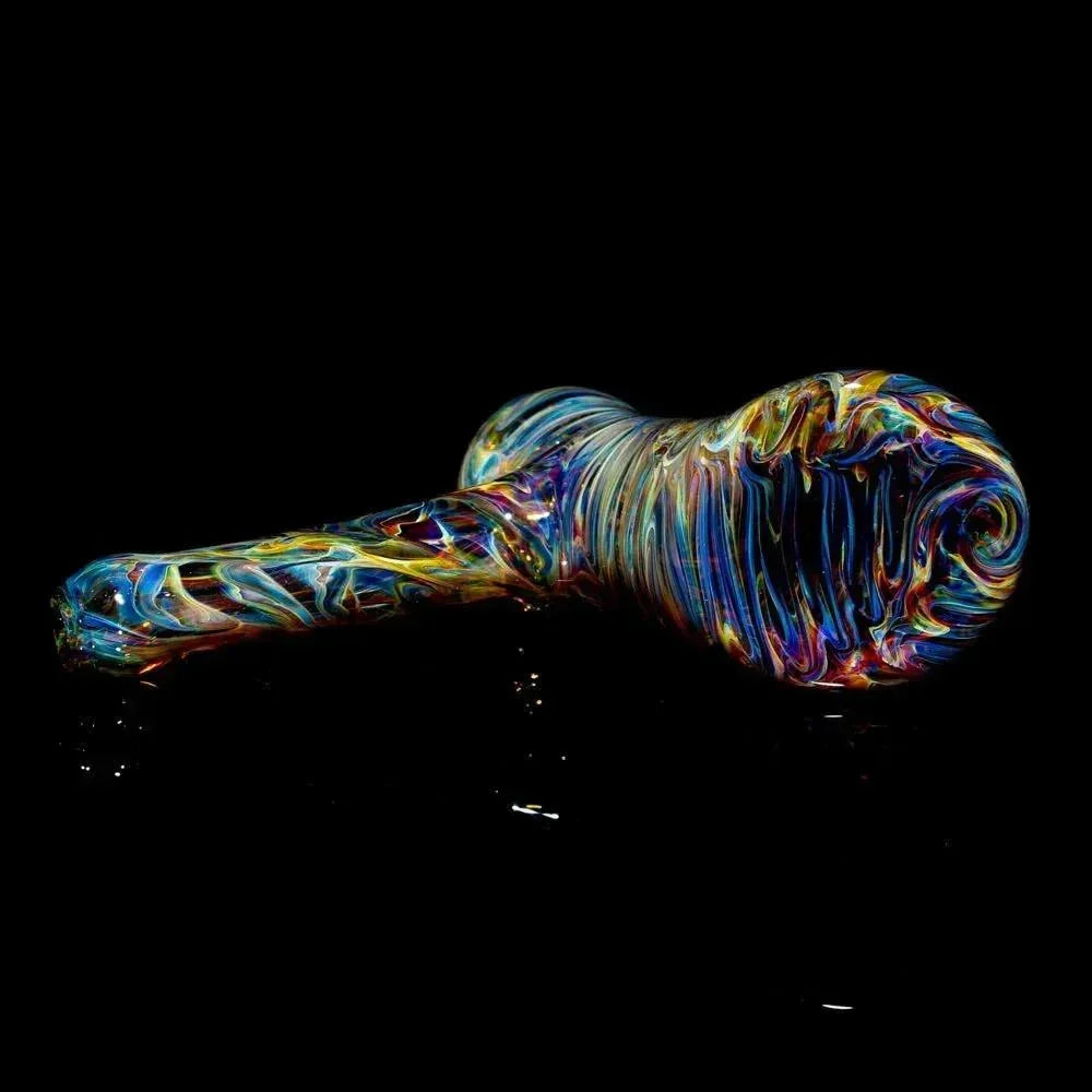 Colorful tie-dye glass hand pipe with swirling patterns on a black background