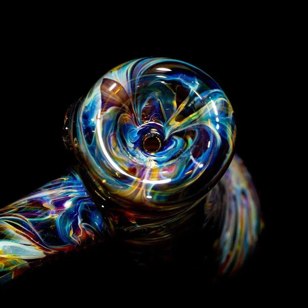 Colorful tie-dye glass hand pipe with swirled pattern on black background