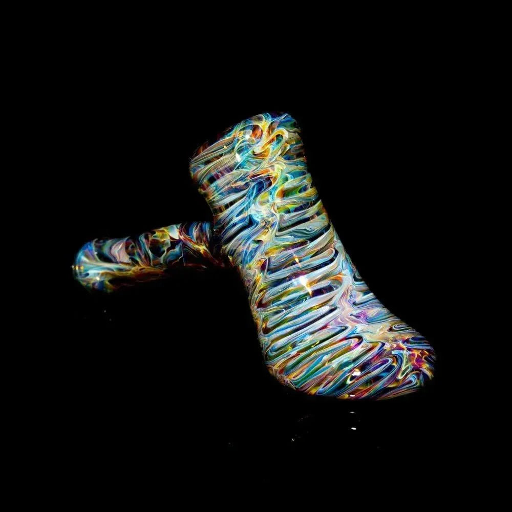 Colorful tie-dye glass hammer pipe with swirled patterns on a black background