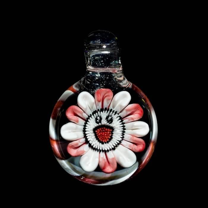 Handblown glass pipe with intricate red and white daisy design, heady glass art for collectors